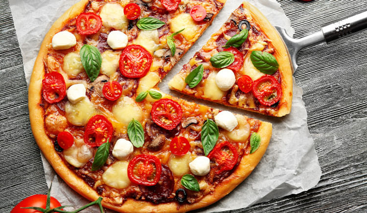 Let your weekend binging plans commence with these drool-worthy pizza serving restaurants in Delhi