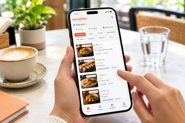 A person scrolling through a restaurant app on a smartphone, filter options visible on screen, modern cafe background, natural light